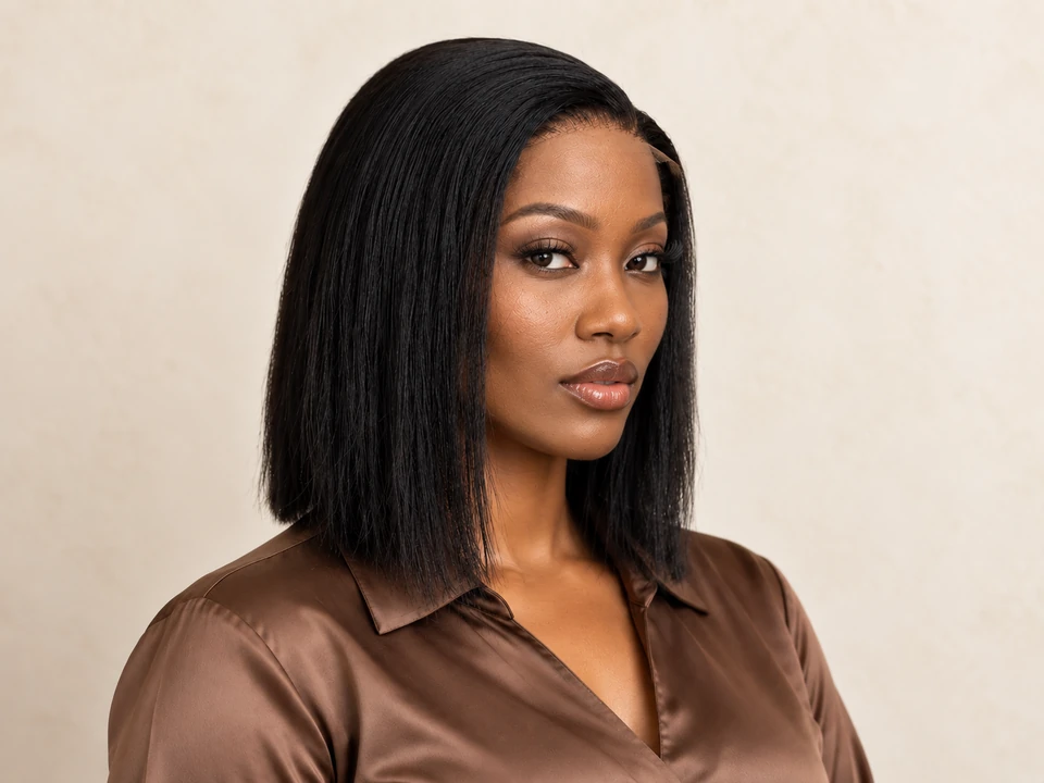 Weaves by Lery campaign model wearing a sleek, side-parted black bob and a brown blouse.